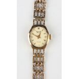 An Accurist Diamond 9ct gold lady's bracelet wristwatch, the signed gilt dial with gilt baton hour