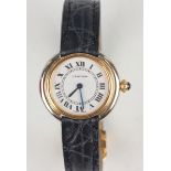 A Cartier 18ct two colour gold circular cased lady's wristwatch, the signed jewelled movement