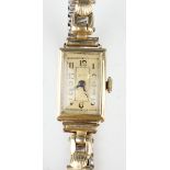 A 14ct gold rectangular cased lady's wristwatch, case width 1.4cm, on a gilt metal expanding