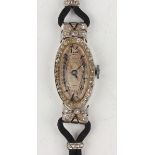 A diamond set oval lady's dress wristwatch with unsigned jewelled movement, the silvered oval dial