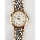 An Omega Deville two tone stainless steel circular cased lady's bracelet wristwatch, Ref. 6360.23.