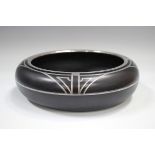 A black glass and silver inlaid circular bowl, in the Art Deco taste, indistinct number to base,