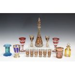 A Bohemian ruby flashed and enamelled glass liqueur set, early 20th century, each piece with a