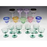 A set of nine harlequin flashed hock glasses, the cut ogee bowls on baluster hexagonal stems, height