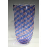 A Murano Venini style glass vase of oval flattened shape with spirals of pink and blue stripes cased