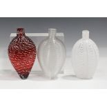 Three Nailsea Gimmel flasks, late 19th century, the first of compressed teardrop shape, its ruby