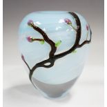 A Siddy Langley studio glass vase, circa 2022, decorated with budding tree branches against a pale