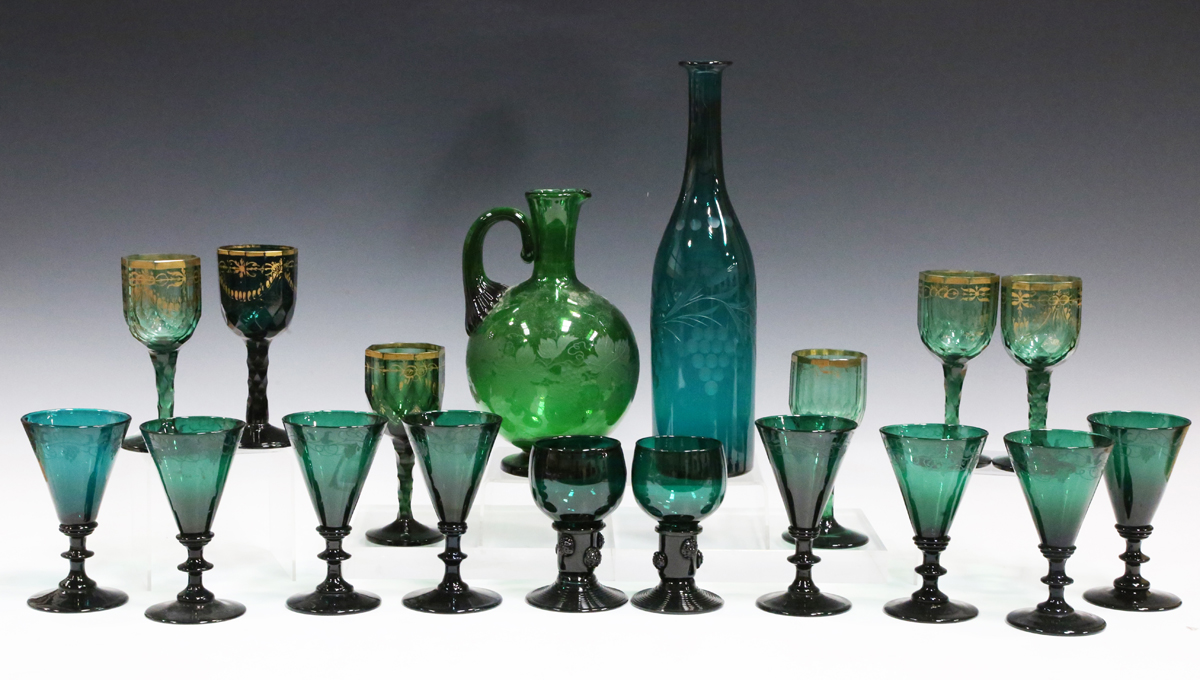 A matched set of eight green glass wines, late 19th/20th century, each conical bowl engraved with