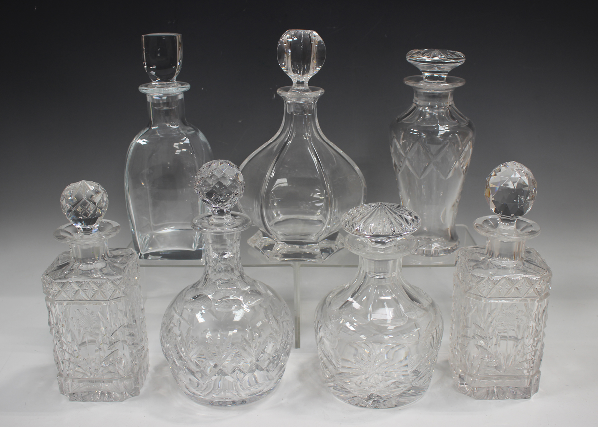 A mixed group of twenty-five assorted glass decanters and stoppers, 20th century, mostly cut