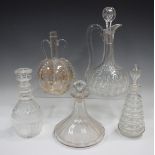 A mixed group of glass decanters and some matched stoppers, 19th century and later, including a gilt