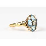 A gold, aquamarine and diamond oval cluster ring, mounted with four oval cut aquamarines