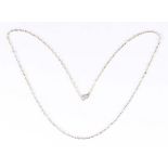 A platinum and seed pearl necklace, the circular links interspersed with seed pearls, on a white