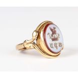 A Victorian gold and sardonyx oval signet ring, engraved with a mystical creature above a crown