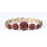 A Bohemian garnet bracelet, designed as a series of garnet set clusters, the principal garnet