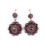 A pair of Bohemian garnet pendant earrings, each designed as a shaped circular cluster with a