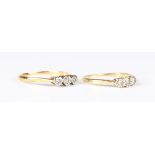 A gold and diamond two stone ring, mounted with circular cut diamonds, detailed '18ct 0.25ct',