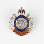 An 18ct two gold, diamond and enamelled military sweetheart brooch, designed as the badge of the