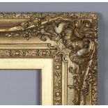 A 19th century swept gilt composition frame of wide section with centre and corner crestings, rebate