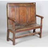 An 18th century provincial oak panel back settle with solid seat and block legs, height 117cm, width