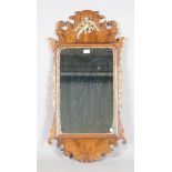 A 20th century George III style walnut and parcel gilt fretwork wall mirror with a carved phoenix