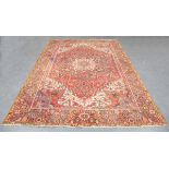 A Heriz carpet, North-west Persia, mid-20th century, the red field with a bold medallion and angular
