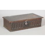 A Charles II oak box, the hinged lid above a carved front, height 16cm, width 60cm, depth 29cm.