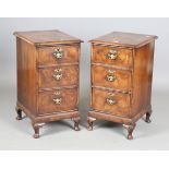 A pair of early 20th century Queen Anne style walnut bedside chests, raised on carved cabriole legs,