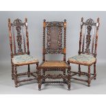 An early 20th century Carolean Revival walnut hall chair, the finely carved back above a caned seat,