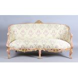 A mid-19th century Rococo Revival gilded showframe salon settee, upholstered in woven patterned