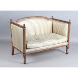 An Edwardian mahogany showframe settee with reeded finials and carved guilloche bands, on cabriole