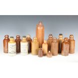 A collection of approximately forty early 20th century stoneware and glass advertising bottles,