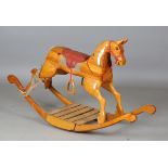 A late 20th century carved pine rocking horse, on a curved rocker base, height 80cm, length 137cm (