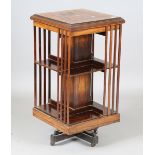 An Edwardian rosewood and boxwood inlaid revolving bookcase, height 92cm, width 46.5cm (faults).