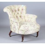 A mid-Victorian buttoned tub back armchair, upholstered in woven patterned damask, on turned legs