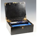 A late Victorian black Morocco leather writing slope with gilded metal mounts, the silk-lined
