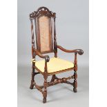 A Charles II oak armchair, the carved and pierced top rail above a caned seat and back, height