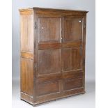 A 19th century oak cupboard, fitted with a pair of panelled doors, height 187cm, width 145cm,