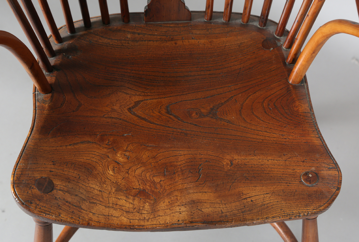 An early Victorian yew and elm stick and wheel back Windsor armchair with shaped panel seat and - Image 11 of 14