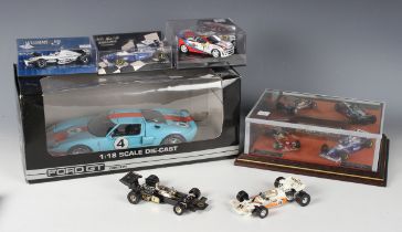 A small collection of model racing cars, including a diorama, titled 'Like Father Like Son',