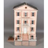 A modern Georgian style doll's townhouse, the double opening front hinged to reveal three rooms, the