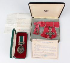 An MBE, civil issue, with a ribbon bow for lady's wear, the corresponding dress miniature award