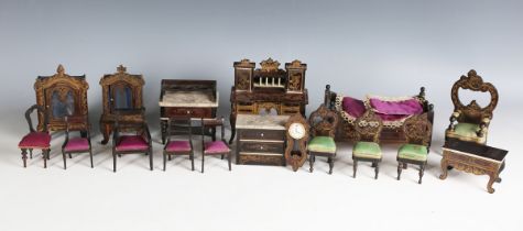 A suite of Walterhausen doll's house furniture, gilt decorated with leaf scrolls and emblems,