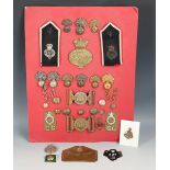 A collection of late 19th and 20th century military buckles, buttons and badges relating to the