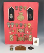 A collection of late 19th and 20th century military buckles, buttons and badges relating to the