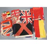 A collection of early to mid-20th century British and international naval ensigns and flags,