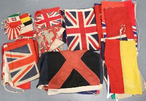 A collection of early to mid-20th century British and international naval ensigns and flags,