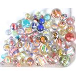 A collection of sixty-six early 20th century and later glass marbles, the majority with