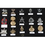 A large collection of 20th century British military and other cap badges, including a silver Buffs