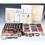 A collection of various militaria, including various cloth badges and buttons and a 1940 MkIII field
