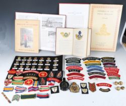 A collection of various militaria, including various cloth badges and buttons and a 1940 MkIII field